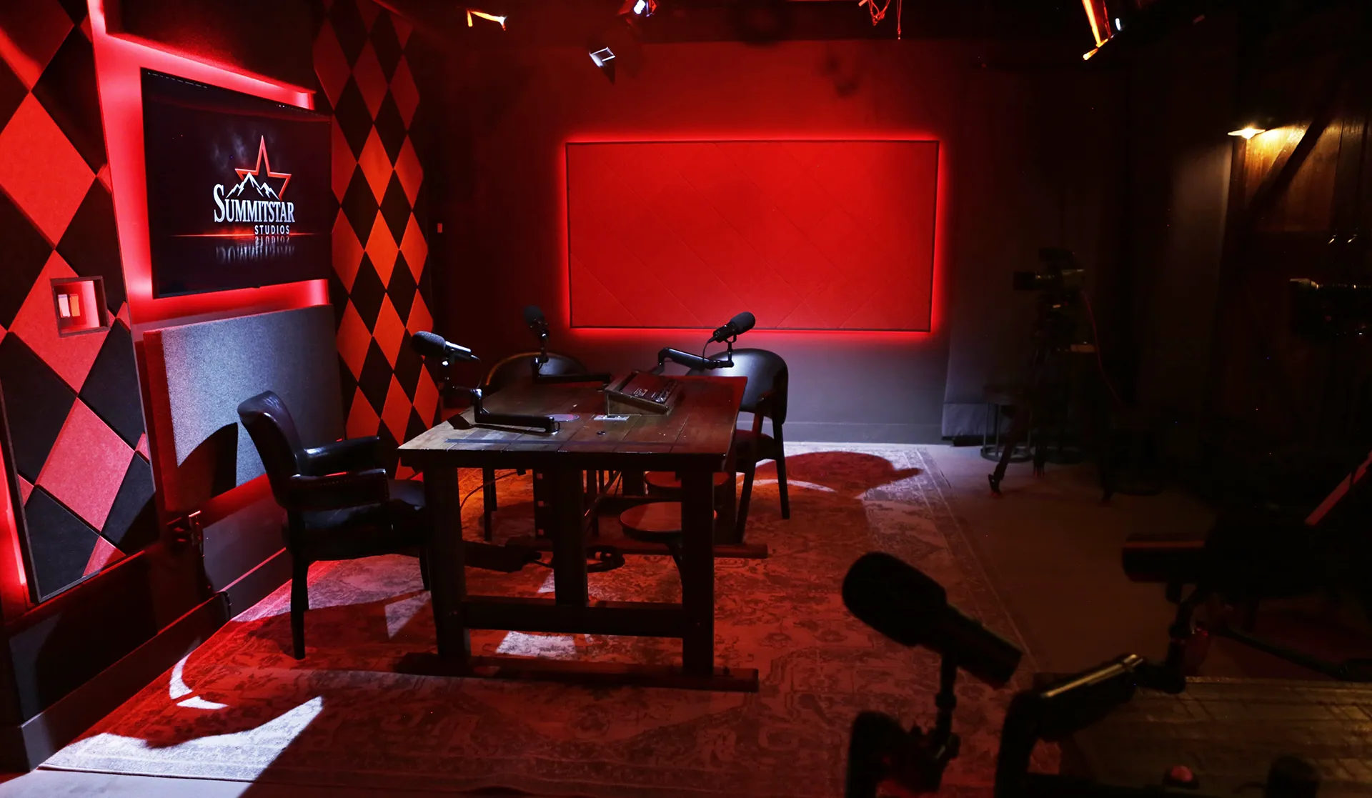 Professional podcast recording studio featuring broadcast microphones, multi-camera production, acoustic treatment, and cinematic lighting at Summitstar Studios in Phoenix, Arizona.